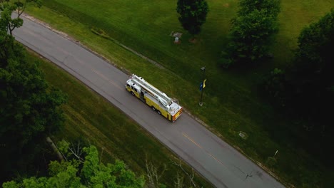 drone shot following a fire truck along a dark rural road