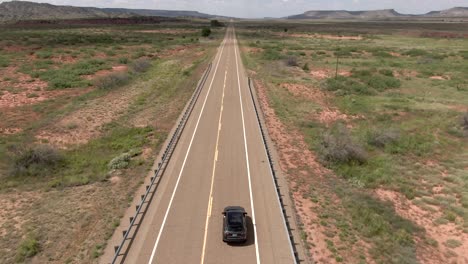 an aerial shot of a car driving along a highway in new mexico usa