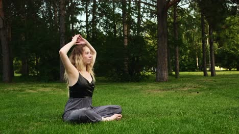 woman practicing yoga in a park