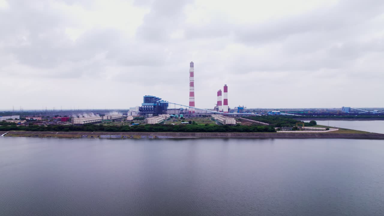 Reveal Shot of NTPC Kudgi with cooling reservoir and smokestacks at karnataka, india. day time, push in shot, drone shot, 4k