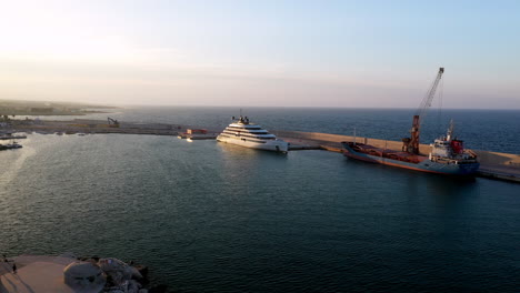 Drone-shot-of-large-yacht-in-dock-in-Puglia,-Italy