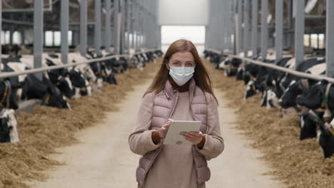 woman in face mask posing at dairy farm