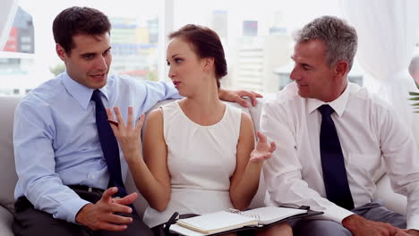 Attractive-businesswoman-discussing-with-colleagues