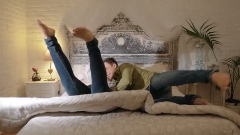 happy couple jumping on the bed