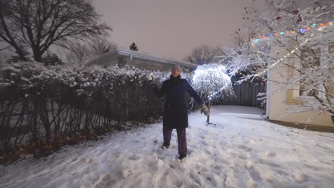 woman throwing a snowball toward the camera