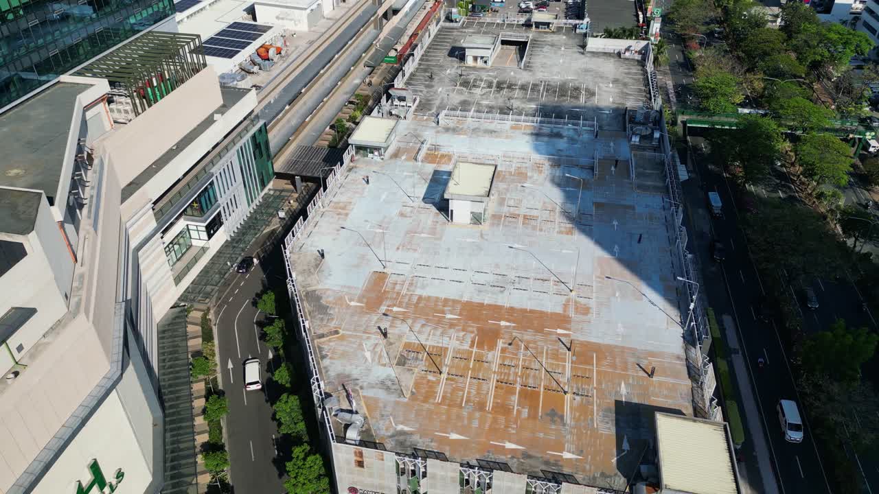 Aerial view of empty rooftop parking lot at Greenhills Shopping Center, San Juan City, Philippines during daytime