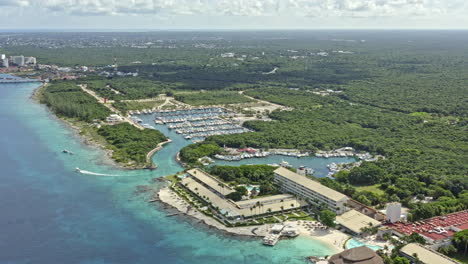 Cozumel-Mexico-Aerial-v5-high-angle-panning-shot-capturing-beautiful-summer-caribbean-sea-landscape-of-marina-caleta-and-nearby-cityscape---September-2020