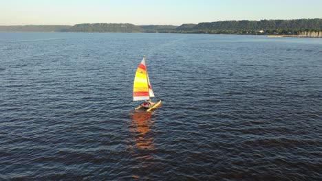 catamaran sailing on river