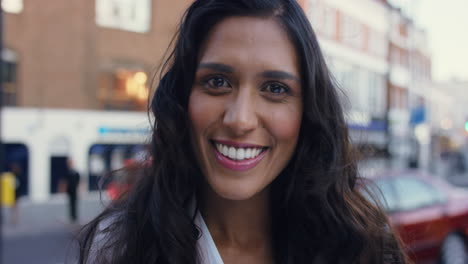 smiling portrait of beautiful woman in the city
