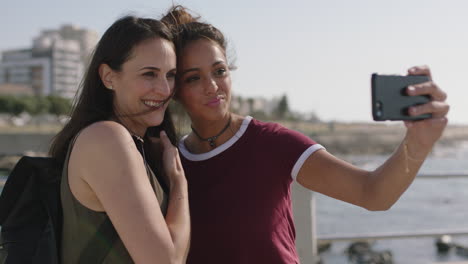 retrato de madre e hija tomando una foto selfie usando un teléfono en una hermosa playa