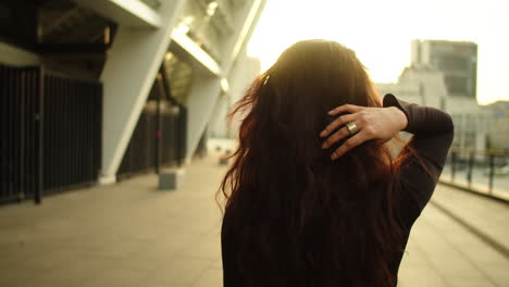 back view of woman entrepreneur in black dress on the street