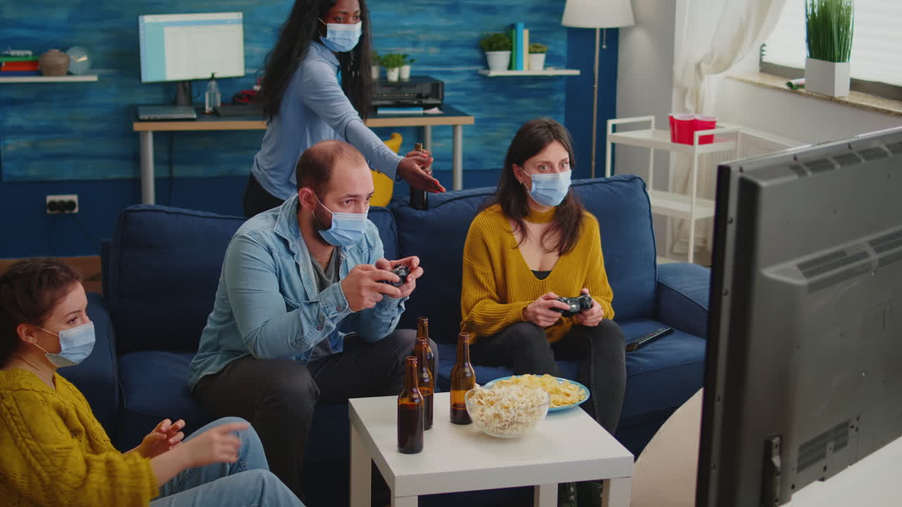 Concentrated multiracial friends playing video games with joystick