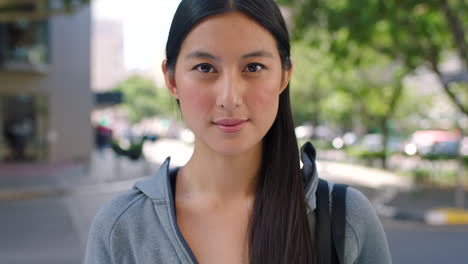 Portrait-of-a-happy-asian-woman-out-traveling