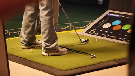 person practicing golf swing alignment indoors