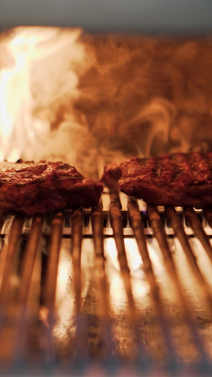 Marinated steak cooking on a grill, receiving heat from intense orange flames, creating sear marks and a delicious sizzle