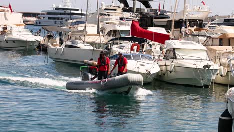 speedboat maneuvering through yachts in monte carlo marina