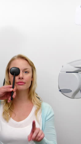 optometrista examinando a una paciente con equipo médico