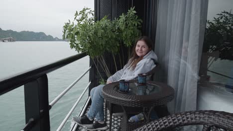 woman sitting on the balcony of a cruise ship