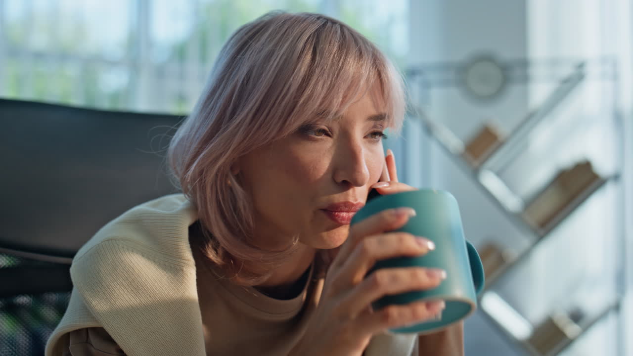 Upset entrepreneur talking smartphone sipping coffee calling workplace portrait