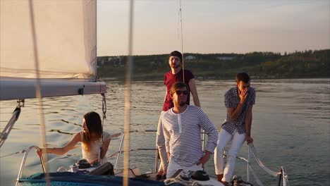 friends enjoying a sunset sailing trip