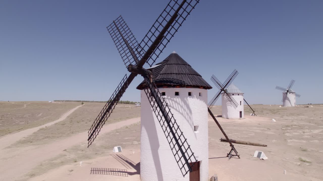 La Mancha. Spanish windmills. Aerial tracking shot. Don Quixote. Panoramic view of ancient windmills at midday. Campo de Criptana. Spain