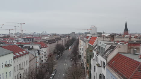 AERIAL:-Slow-flight-through-Empty-Central-Berlin-Neighbourhood-Street-Torstrasse-over-Rooftops-during-Coronavirus-COVID-19-on-Overcast-Cloudy-Day