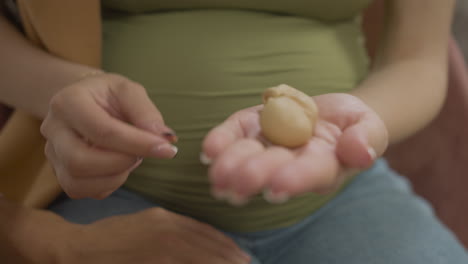 pregnant couple holding toy baby