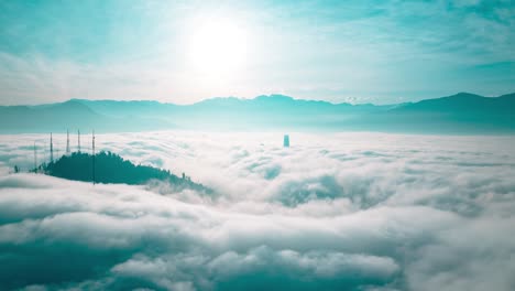 Aerial-Hyperlapse-Above-the-Clouds-of-Santiago-de-Chile-Andean-Cordillera-Hills,-Cloudy-Sky-in-Motion-around-San-Cristobal-Mountain,-Cordillera-and-Virgin-Mary-Landmark