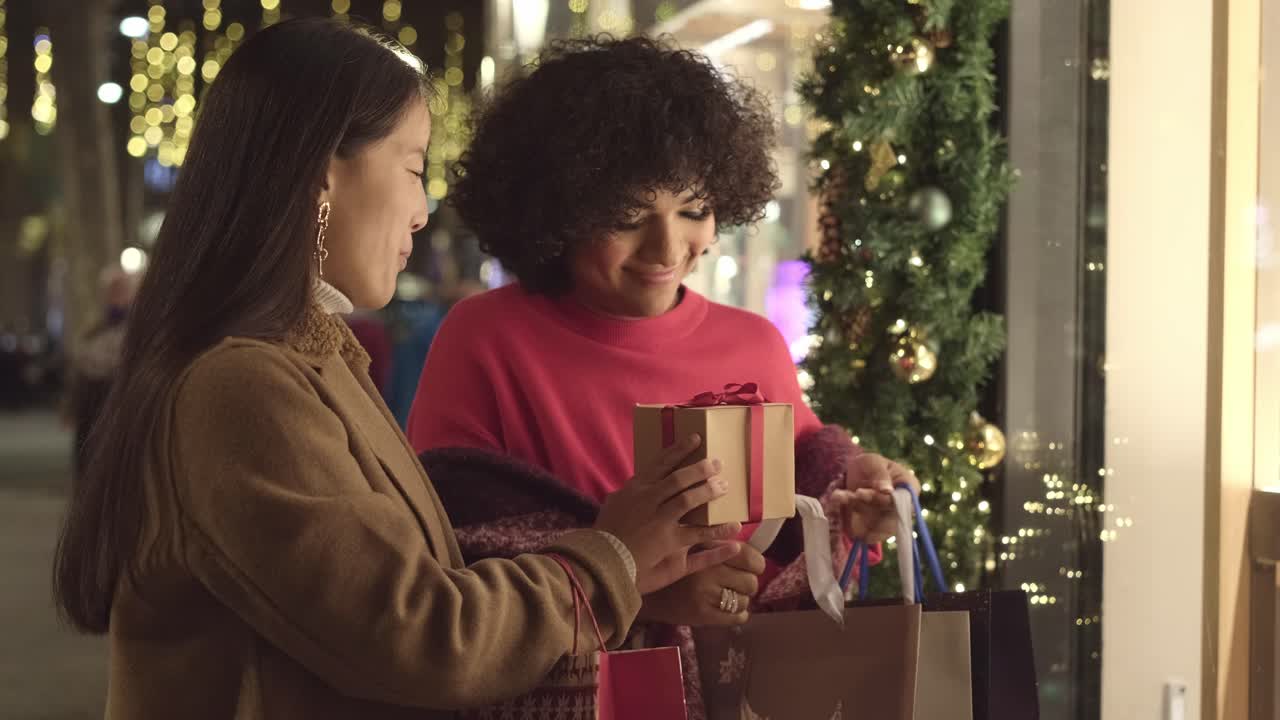 Women exchanging a Christmas gift