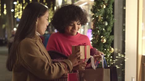 women exchanging a christmas gift