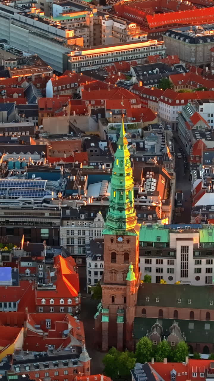 Aerial drone view of the Christiansborg Palace on the islet of Slotsholmen in central Copenhagen, Denmark at sunset. Vertical