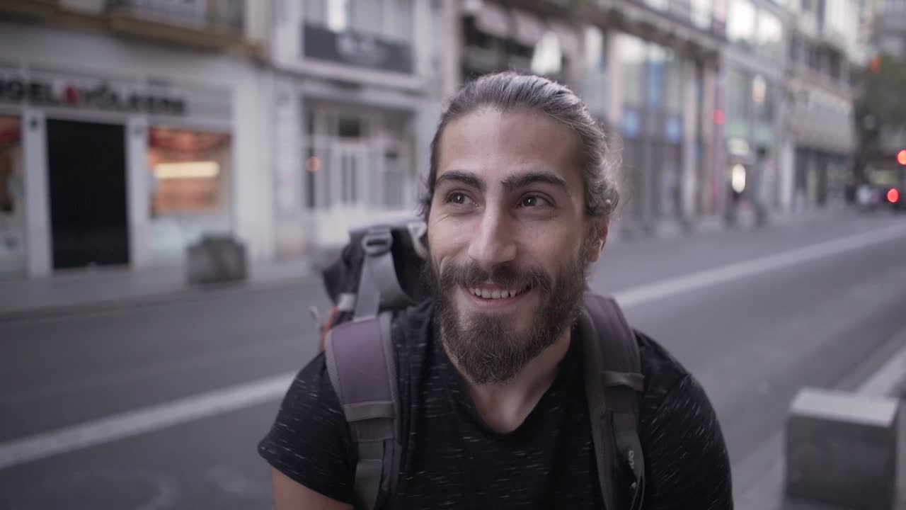 Man with backpack in city street