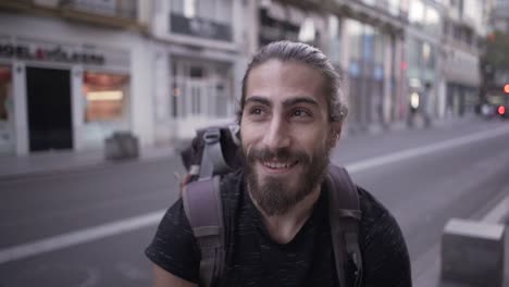 man with backpack in city street
