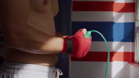 Side-view-of-caucasian-man-working-out-in-boxing-gym