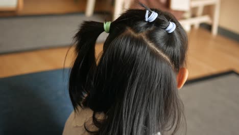 child with ponytails