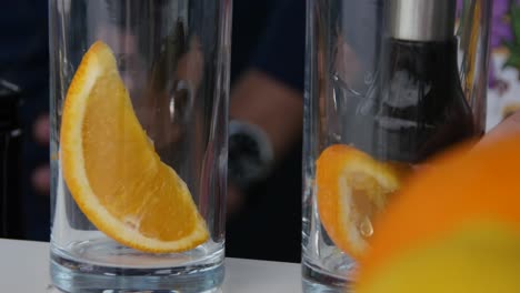 bartender making a cocktail with orange slice