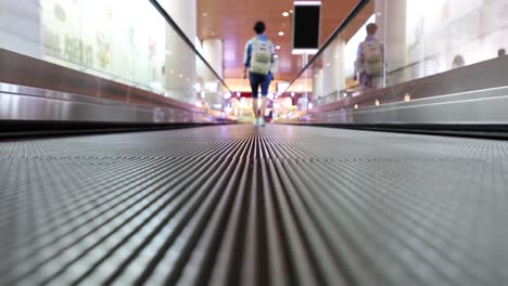 moving walkway at the airport, also known as an autowalk, moving sidewalk, moving pavement, people-mover, travolator, or travelator, is a slow-moving conveyor mechanism that transports people.