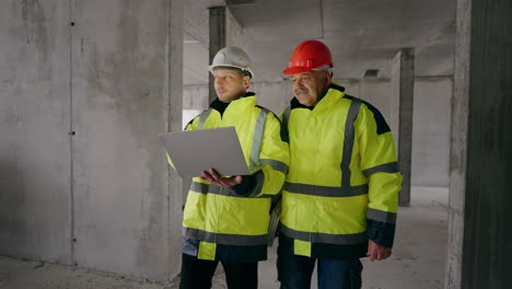 civil engineer and foreman are viewing and examining under-construction building