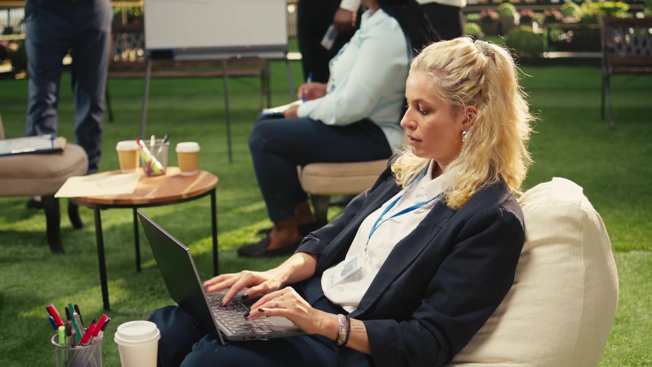 Professional Woman Working on Laptop in Outdoor Office Setting