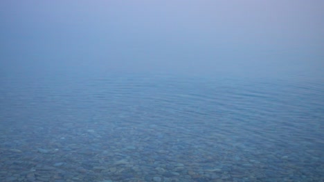 beautiful morning calm water surface with fog.