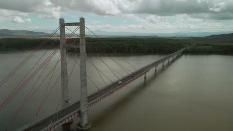 vehicles crossing long bridge over amazon river in south america