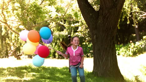 girl jumping in slow motion with balloons