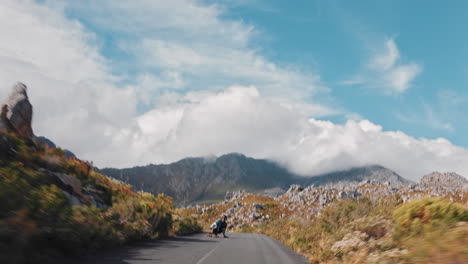 young man riding longboard skating cruising fast downhill using skateboard on beautiful countryside road wearing protective helmet