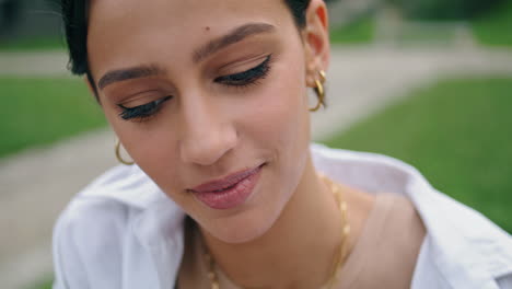 closeup latina woman talking outdoors. serious student girl speaking at nature