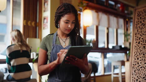 a woman holding a tablet in a restaurant