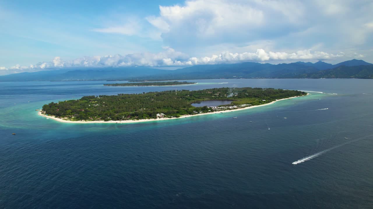 Gili Meno island with boat passing, high aerial establishing Indonesia