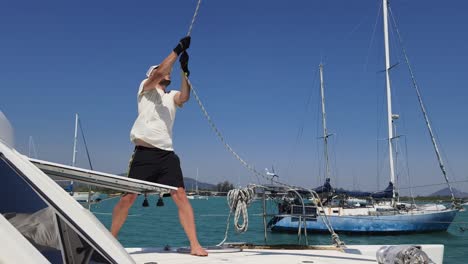 sailor handling lines on a yacht