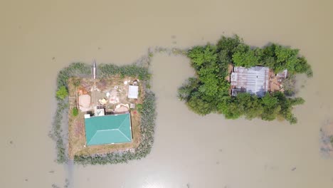 lowering on settlements in the flooded rural village of bangladesh, south asia. aerial descending shot