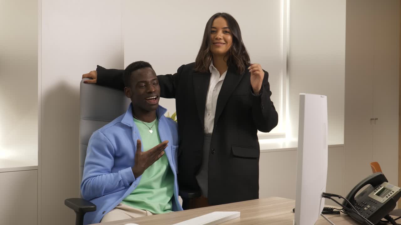 Business colleagues sharing laughter and dancing in office