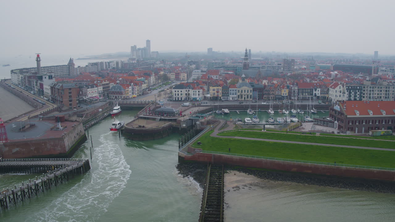 Harbor town, waterway, red rooftops, and cloudy sky, serene atmosphere, aerial view